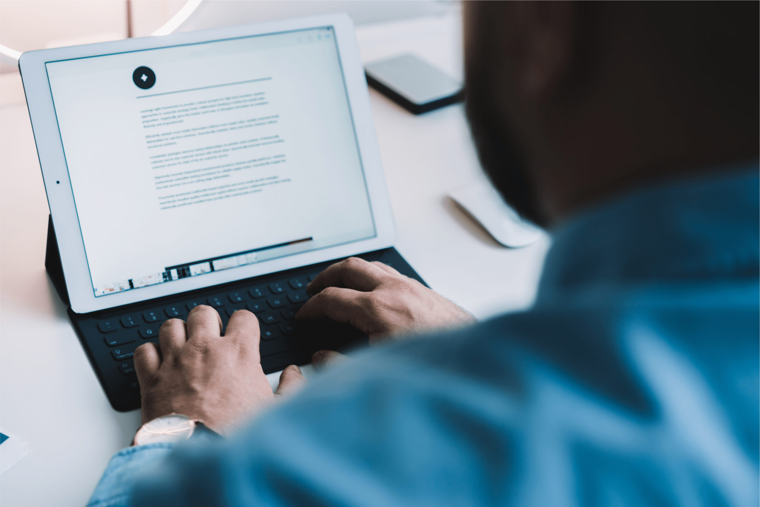 A man writing a blog on an iPad.