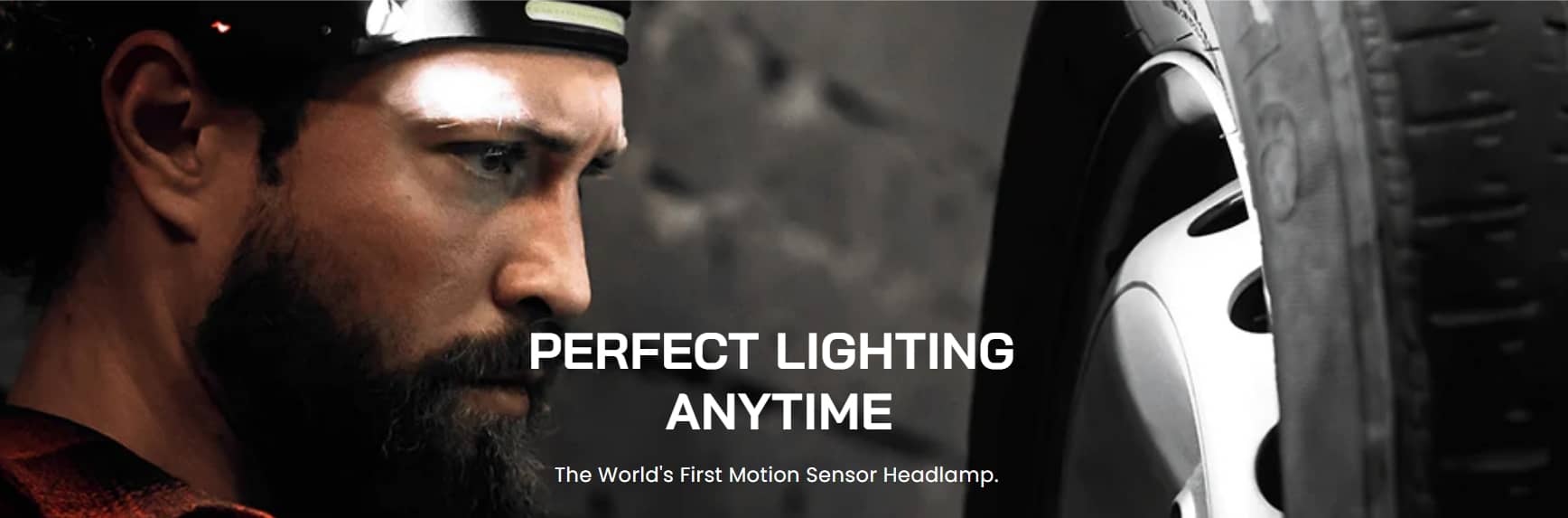 Man using WaveBeamPro motion sensor headlamp for hands-free lighting during car repair