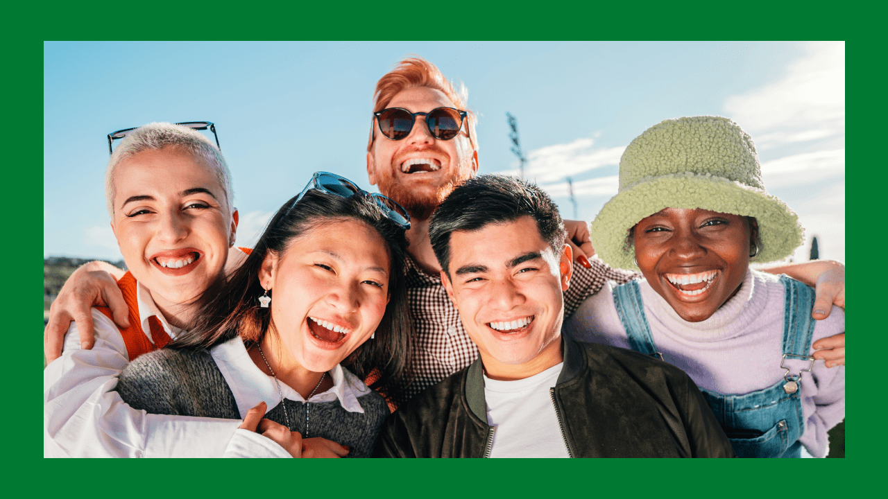 Group of diverse young adults smiling outdoors, reflecting strategies on how to market to different generations.