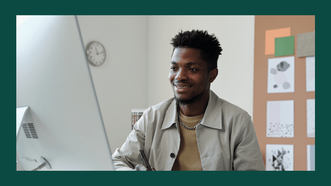 Designer working at a desktop, planning how to start a print-on-demand business website.