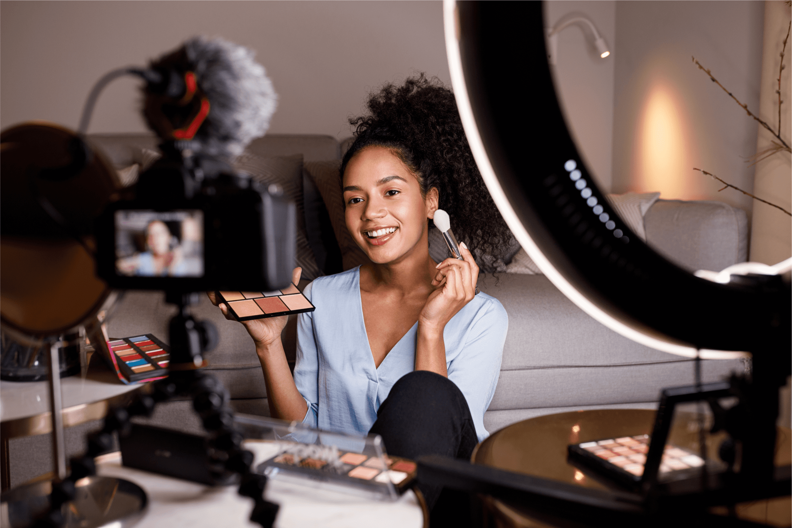 A woman shooting a makeup tutorial for YouTube.