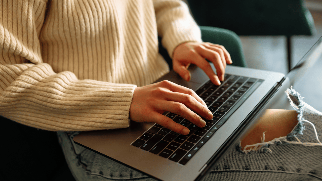 Online seller reviewing e-commerce laws while working on a laptop.